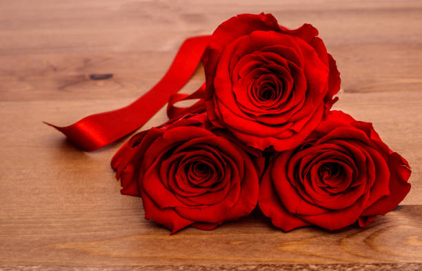 istock Roses and on wooden background 1094732048