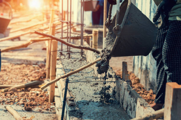 istock worker mixing pour construction cement on floor for building house 1094742284