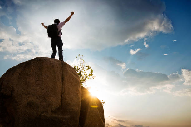 istock Man at mountain top with arms outstretched 1094745252