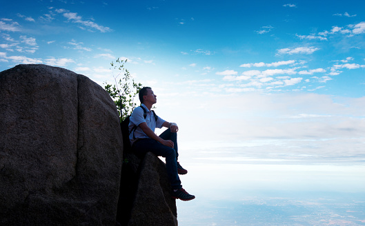 Man sitting on top of the mountain.