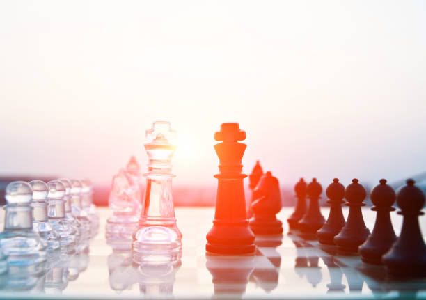 istock Transparent and black chess pieces on the board 1094749500