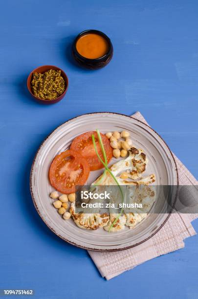 Roast Cauliflower Steak Stock Photo - Download Image Now - Backgrounds, Baked, Blue