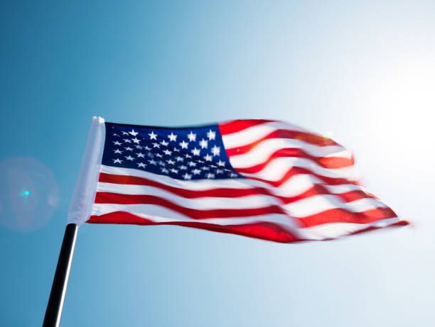 istock American flag waving against blue sky 1094759424