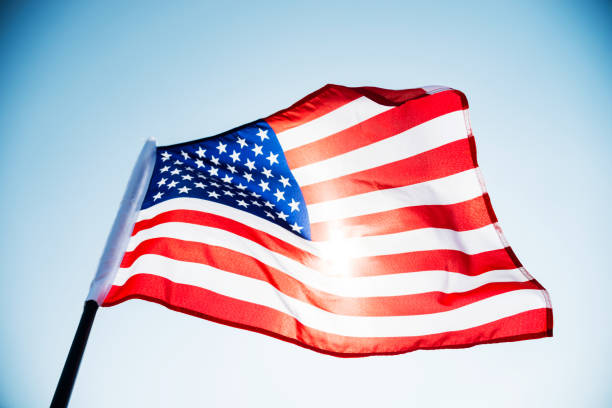 istock American flag waving against blue sky 1094759448