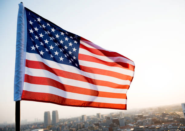 istock American flag waving in sunset 1094760812