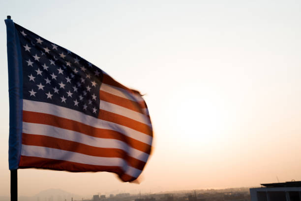 istock American flag waving in sunset 1094760838