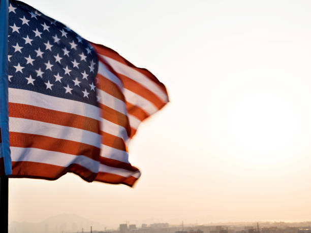 istock American flag waving in sunset 1094760844