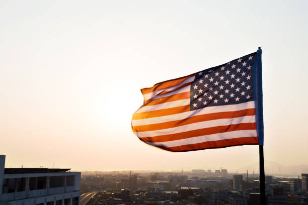 istock American flag waving in sunset 1094760862