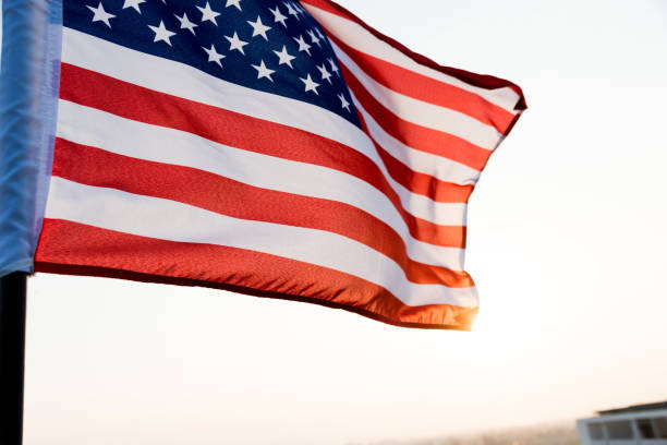istock American flag waving in sunset 1094760864