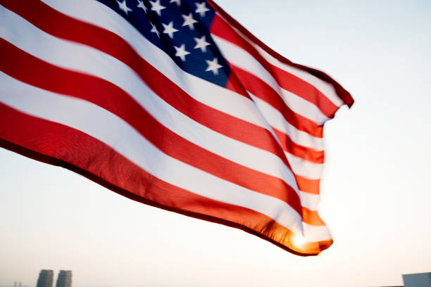 istock American flag waving in sunset 1094760878