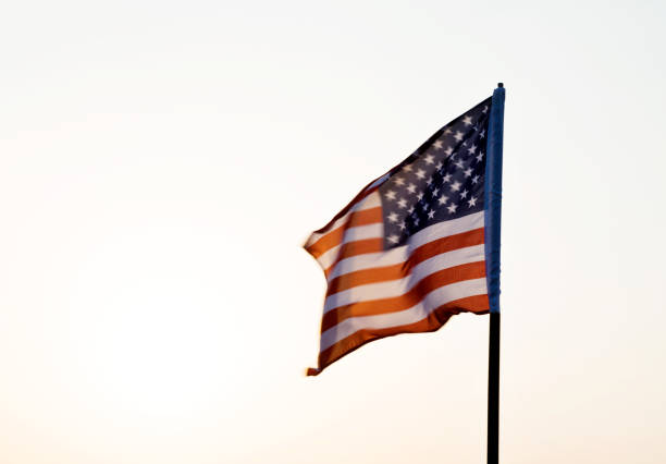 istock American flag waving in sunset 1094760890