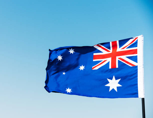 istock Waving Australia flag against blue sky 1094760922