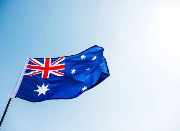 istock Waving Australia flag against blue sky 1094760956