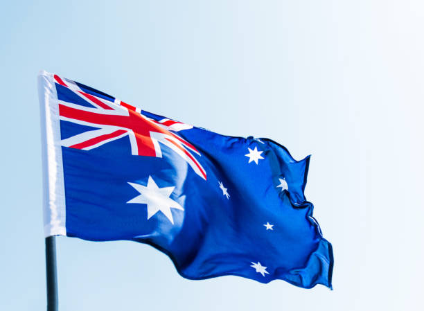 istock Waving Australia flag against blue sky 1094760988
