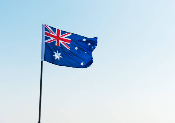 istock Waving Australia flag against blue sky 1094761014