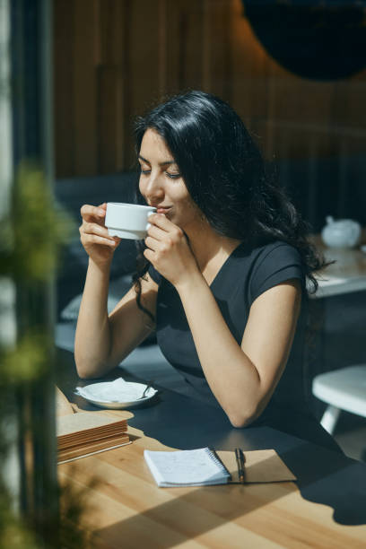 istock young Arabic woman drinking coffee at a cafe 1094761466