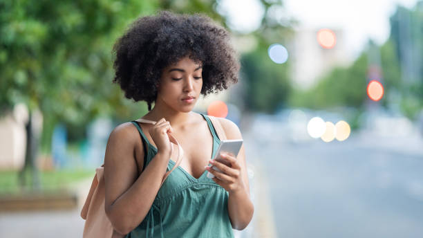 istock Woman using phone on street 1094765930
