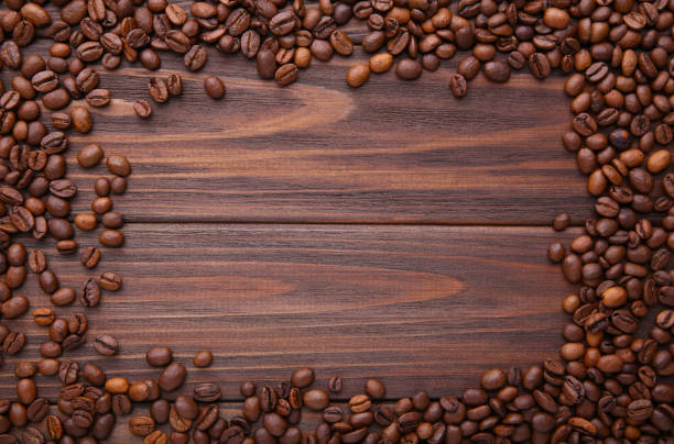 istock Natural coffee beans on brown wooden background 1094765940