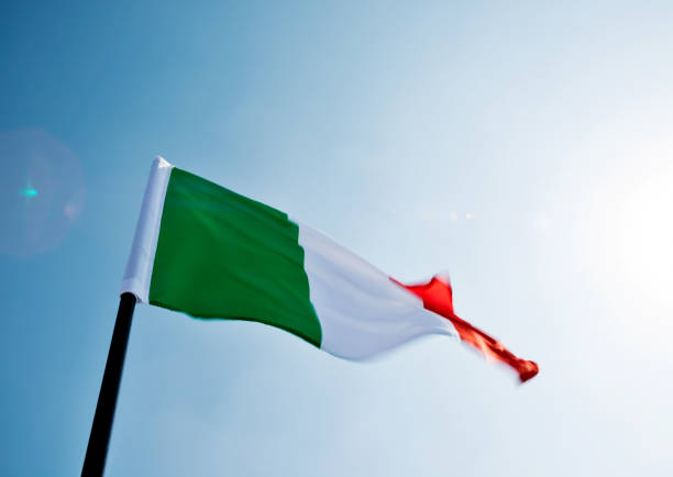istock Italian flag waving in the sky 1094766236