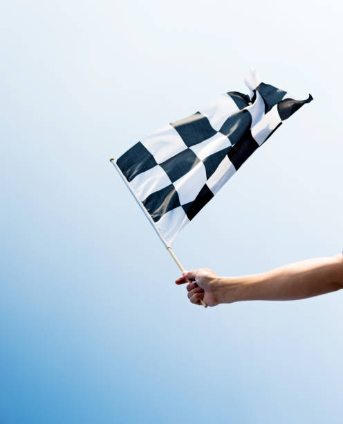 istock Man hand holding checkered flag in the wind 1094767418