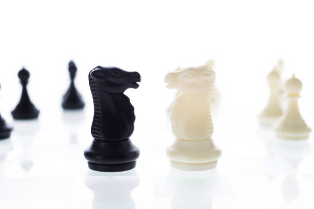 A close-up of a chessboard highlighting the white KING standing out among black pieces, symbolizing strategic thinking, leadership, and decisive planning in overcoming challenges and achieving goals