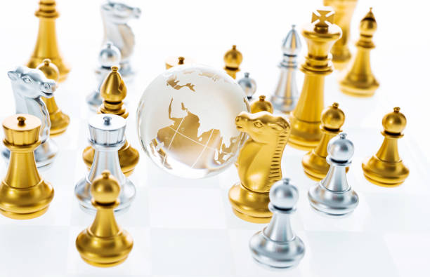 istock Chess pieces and glass earth globe on the board 1094770718