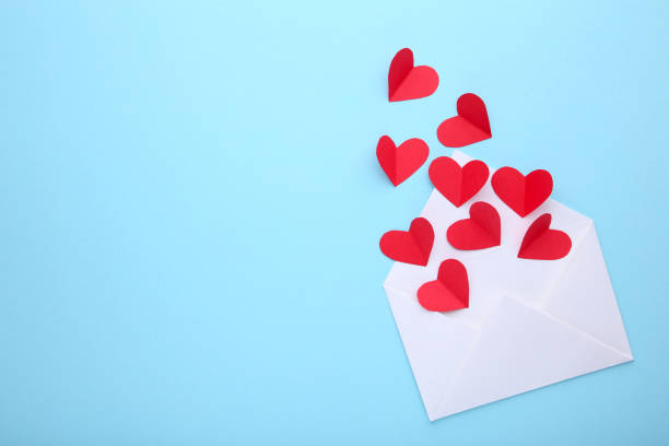 istock Valentines day greeting card. Handmaded red hearts in envelope on blue background. 1094772226