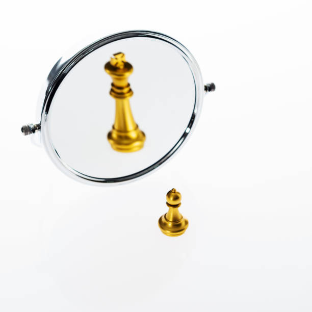 istock Golden chess pawn imagining itself as a king 1094776222