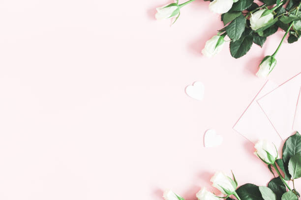 istock Flowers composition. White rose flowers, envelopes on pastel pink background. Valentines day, mothers day, womens day concept. Flat lay, top view, copy space 1094777002