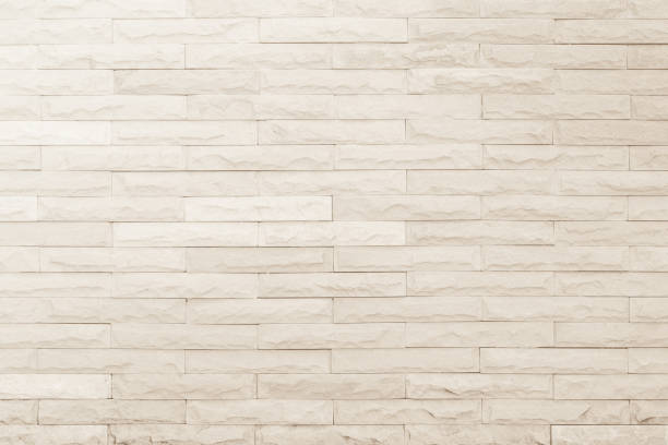 istock Seamless Cream pattern of decorative brick sandstone wall surface with concrete of modern style design decorative uneven have cracked realmasonry wall of multicolored stones or blocks white cement. 1094780302