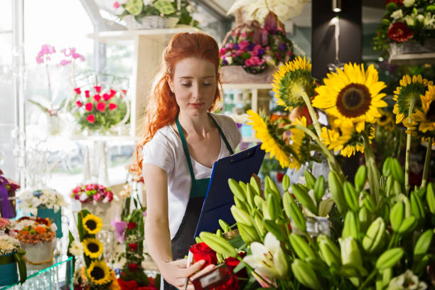 istock Young woman arranging flowers 1094780510