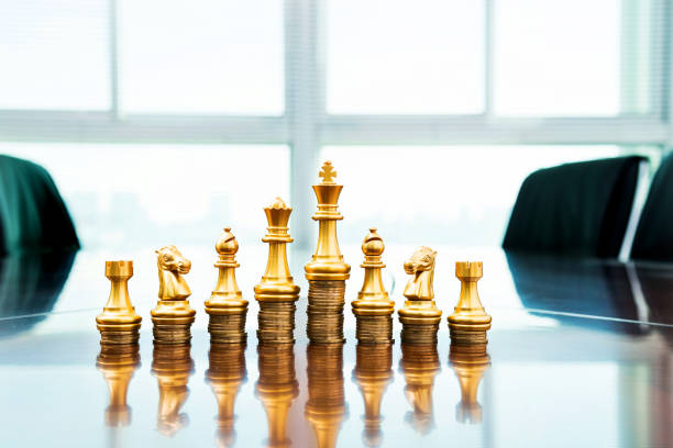 istock Chess pieces standing on the stacked coins 1094781238