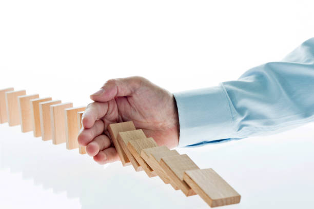 istock Businessman hand stop domino effect 1094782734