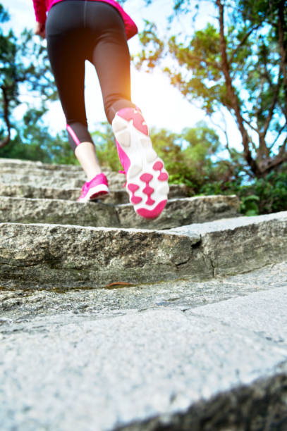 istock Woman feet running on the steps 1094784926