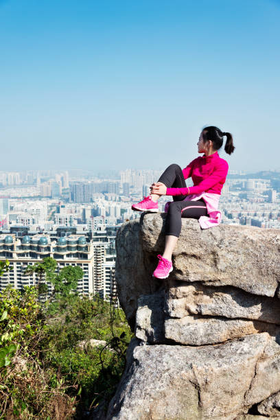 istock Woman sitting on mountain top enjoy the view 1094785834