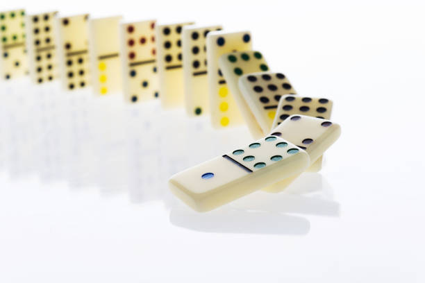 A row of spotted dominos falling down