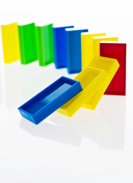 A line of colorful dominos falling down