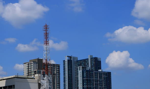 antenna tower among high-rise buildings stock photo