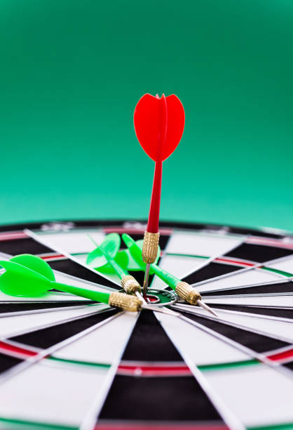 istock Red and green dart arrows on dartboard 1094789902