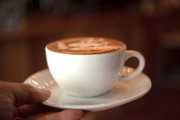 istock hand holding a cup of coffee 1094791874