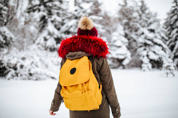 istock Young woman enjoying winter walk on snow 1094792480
