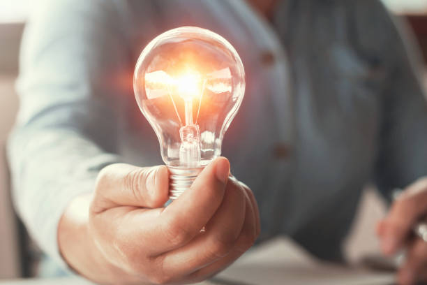 istock hand holding light bulb energy power concept 1094793838