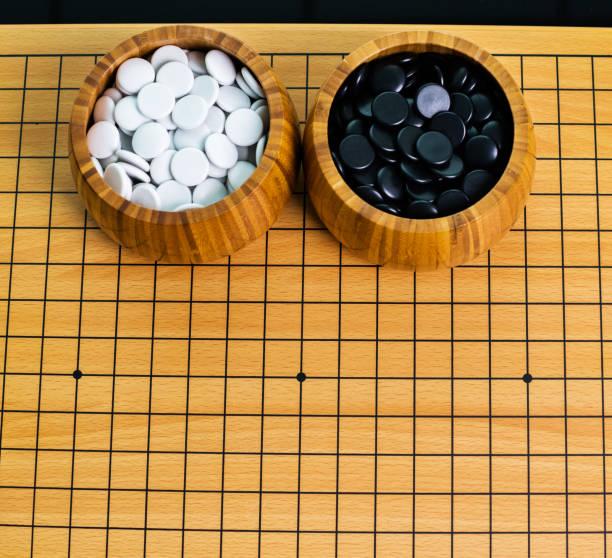 istock Go game pieces in wooden bowls 1094795466