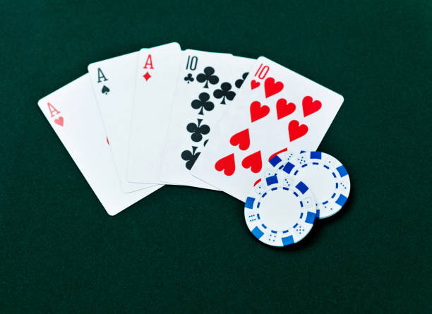 istock Full house and poker chips on card table 1094796872