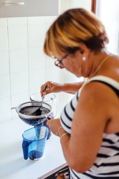 istock Woman cooking blackberry jam 1094798030