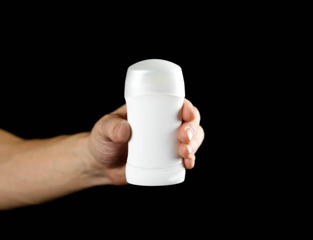 istock Hand holding white antiperspirant. Close up. Isolated on black background 1094801006