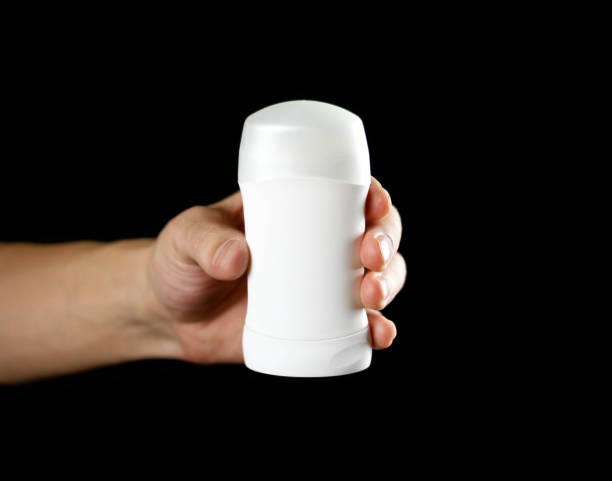 istock Hand holding white antiperspirant. Close up. Isolated on black background 1094801038