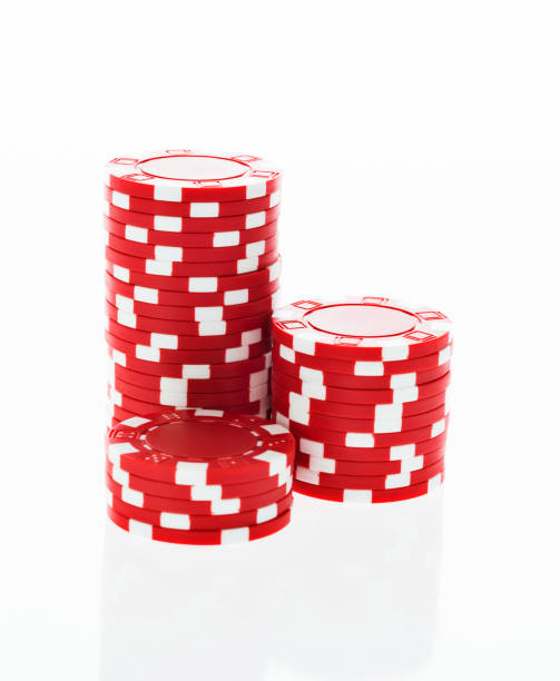 three stacks of red poker chips on white background - arts symbols studio shot selective focus entertainment imagens e fotografias de stock