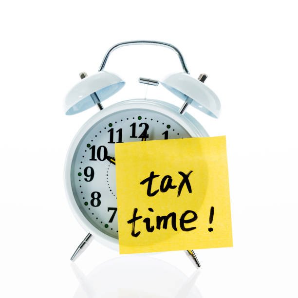 istock A clock with tax time sticky note on white background 1094806312