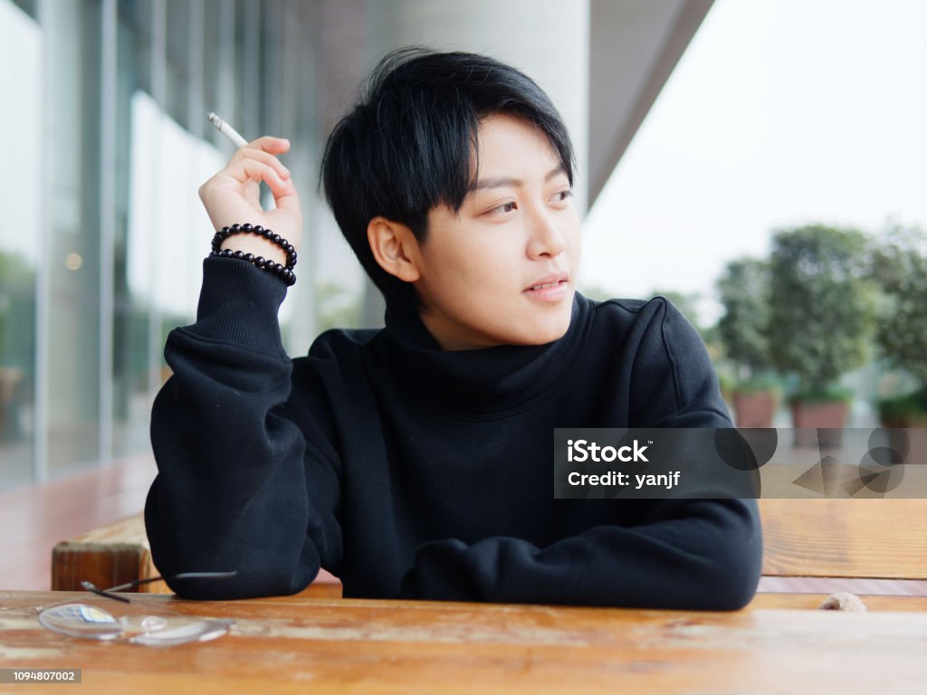 Portrait Of Cute Beautiful Young Lesbian With Short Haircut And Trendy  Boyish Clothes Sitting Outside With Cigarette In Hand Cool Chinese Gay Girl  Stock Photo - Download Image Now - iStock